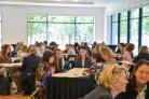 People working in groups at tables