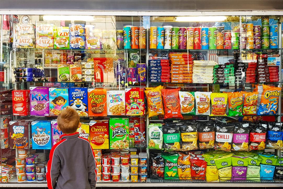 A child standing in front of a candy aisle