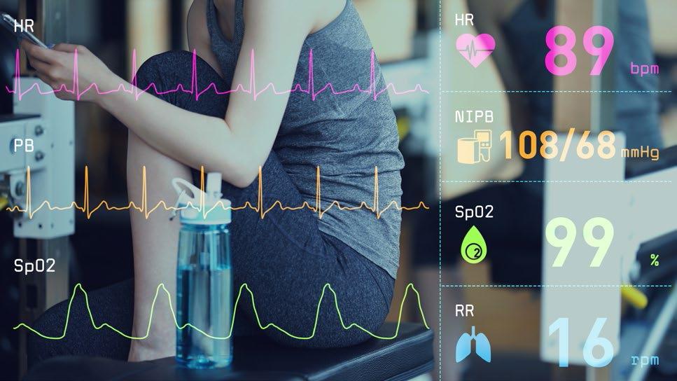 A woman is checking her heatbeat etc. on her phone after a work-out